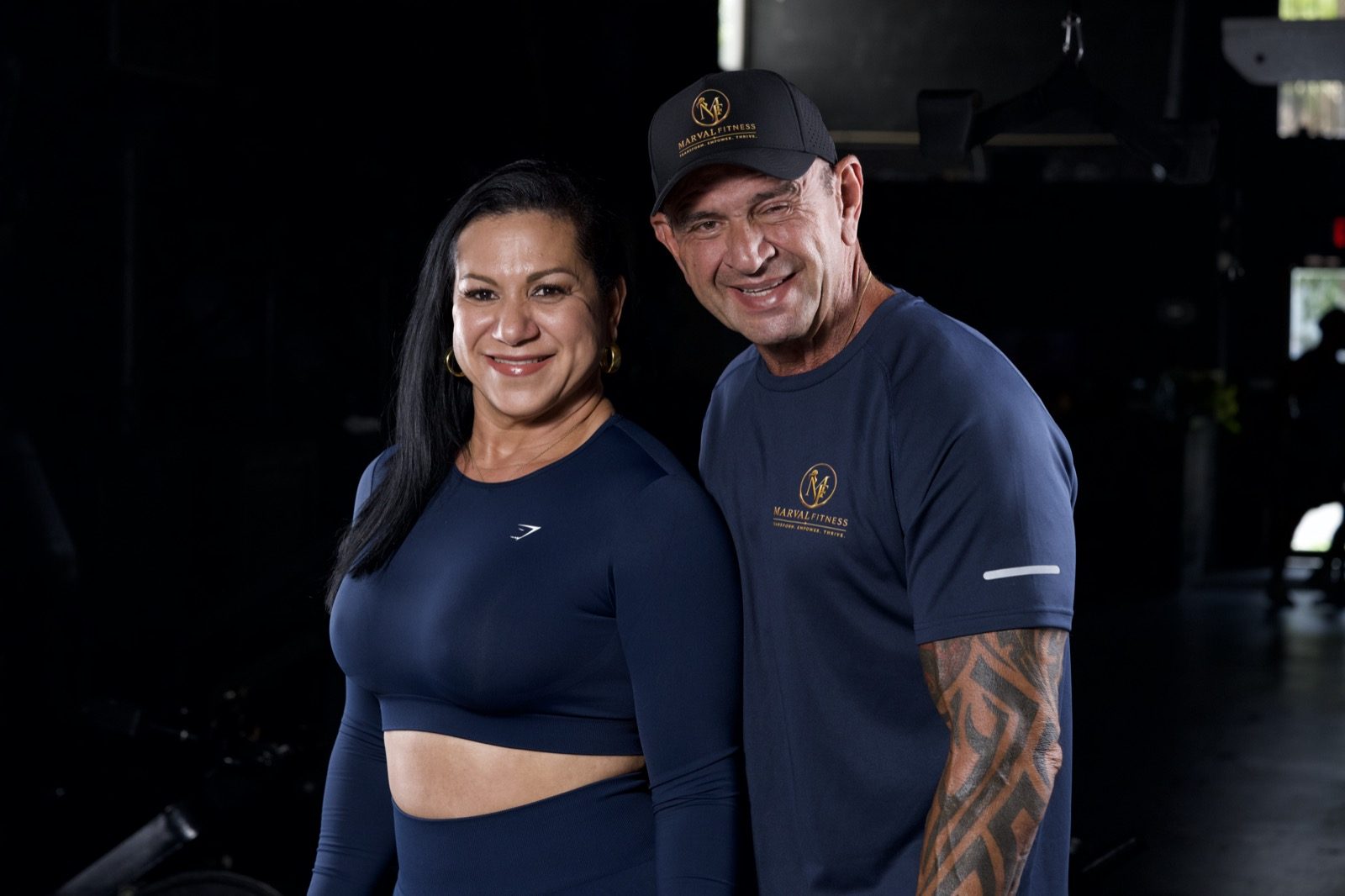 Karina Marval and Jorge Gonzalez flexing together